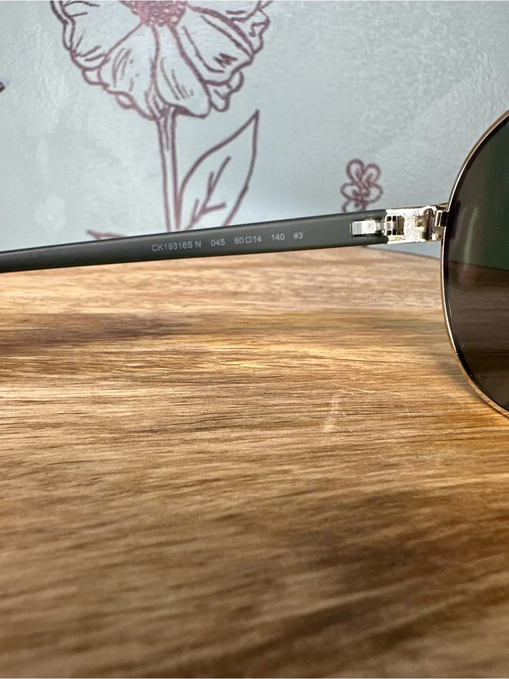 Calvin Klein Men’s Silver Frame Sunglasses with Black Lenses